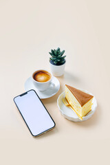 Blank screen mobile phone on coffee table top.