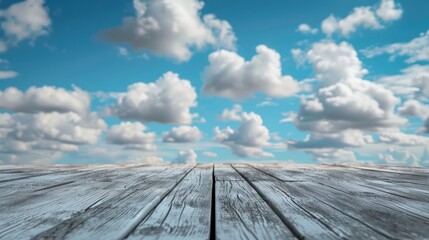 Weathered wooden floor with a backdrop of clear blue skies and white clouds