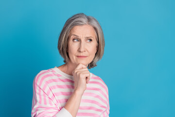 Photo portrait of attractive retired woman look empty space skeptical dressed stylish striped...