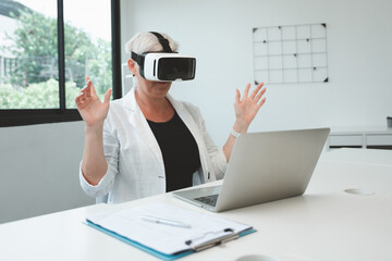 Woman wearing a white shirt and black jacket is wearing a virtual reality headset.