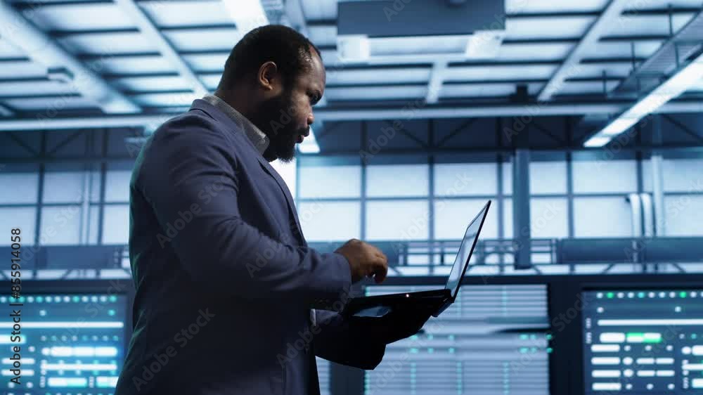 Poster admin doing yearly checkup using notebook to prolong data center electronics life span and avoid dow