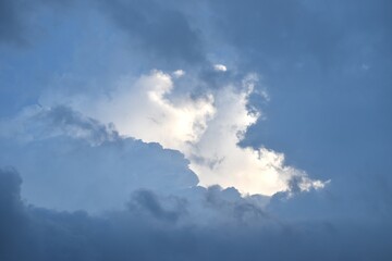 dark rain cloud floating and spreading on twilight sky in evening 