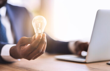 African american businessman with illuminated light bulb, concept for idea, innovation and...