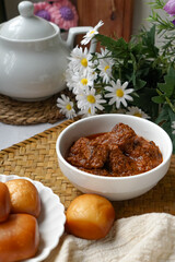Rendang Daging, a Malaysian traditional dish featuring tender meat cooked in coconut milk and a blend of aromatic spices.