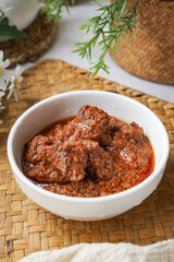 Rendang Daging, a Malaysian traditional dish featuring tender meat cooked in coconut milk and a blend of aromatic spices.