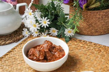 Rendang Daging, a Malaysian traditional dish featuring tender meat cooked in coconut milk and a blend of aromatic spices.