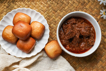 Fried Mantou served in white plate with Beef Rendang.  Fusion food.