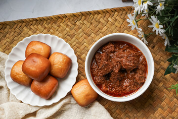 Fried Mantou served in white plate with Beef Rendang.  Fusion food.