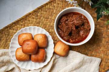 Fried Mantou served in white plate with Beef Rendang.  Fusion food.