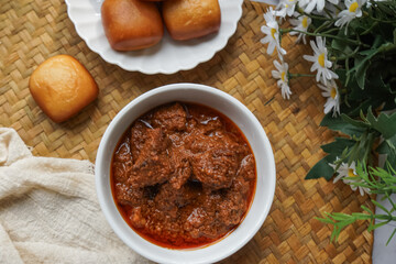 Fried Mantou served in white plate with Beef Rendang.  Fusion food.