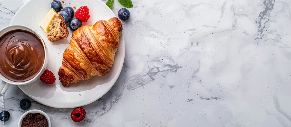 Poster croissant with fresh berries, chocolate spread and butter with cup of coffee on a marble texture bac