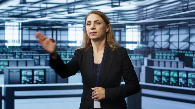 System administrator in high tech data center looking at hologram visualization. Computer scientist working on securing server terminals using AR tech, preventing hacker attacks, camera A