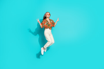 Full length photo of shiny attractive lady dressed print shirt showing v-signs jumping high empty space isolated blue color background