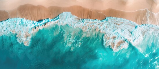 Aerial drone footage of sea ocean waves reaching shore.Beach with aerial drone. Beach clear turquoise top view. Beautiful beach. Copy space image. Place for adding text or design