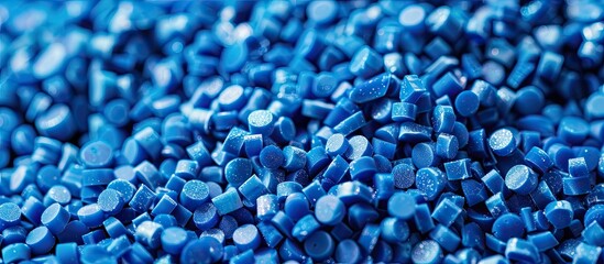 Close-up of blue plastic polymer granules. polymer plastic. compound polymer. PVC resin compounds. Tinted plastic granulate for injection moulding process. Copy space image
