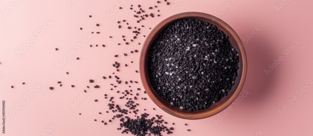 Poster black salt with isolated on pastel background salt powder. copy space image. place for adding text a