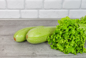zucchini and salad are on the kitchen table