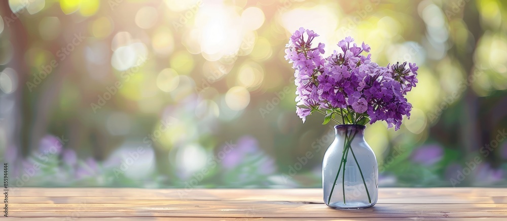 Poster purple flower in lamp vase on wood table with blur background. copy space image. place for adding te