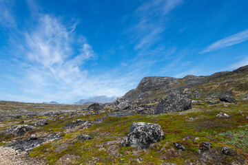 Greenland Nanortalik lava stones volcanic mountain fjord arctic landscape on a sunny day