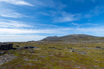 Greenland Nanortalik lava stones volcanic mountain fjord arctic landscape on a sunny day