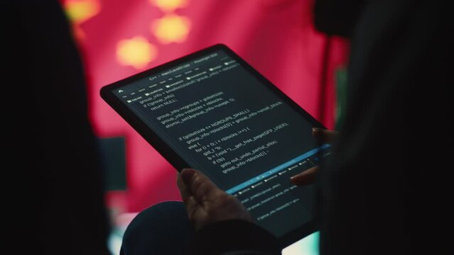 Chinese hacker uses a tablet in governmental cyber operations office to work on hybrid warfare and political manipulation. Inflicting manipulation and propaganda for the communism ideology. Camera A.