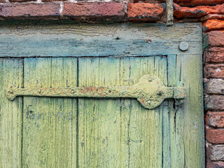 Close up of an old wall with wooden door