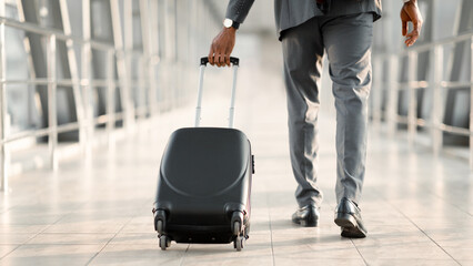 Businessman At Airport Moving To Terminal Gate For Business Trip, Back View