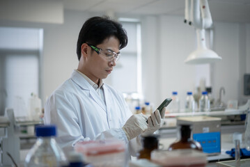 doctor using mobile phone in lab