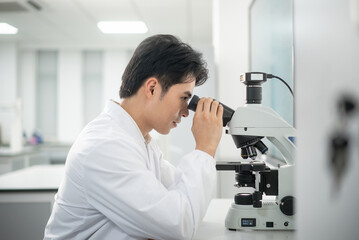 doctor using microscope in lab
