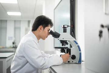 doctor using microscope in lab