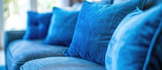 Obraz premium Close up detail of blue pillow on sofa in a home. Copy space image. Place for adding text and design