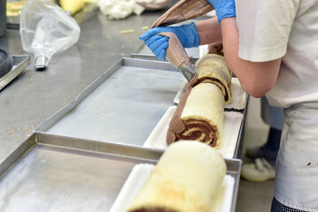 industrial production of cakes and tarts in a large bakery on an assembly line