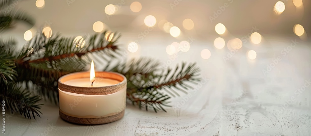 Poster a candle and a branch of a fir tree on a light background. cozy house . copy space image. place for 