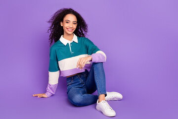 Full body portrait of lovely young girl sit floor empty space wear shirt isolated on purple color background