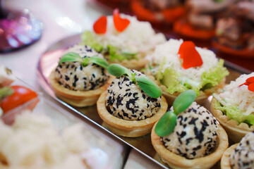Tartlets with pate decorated with micro greens. Delicious and beautiful appetizers for a buffet table. catering services for banquets.