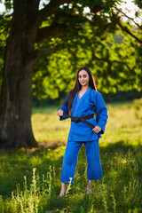 Beautiful latin judoka woman in the forest