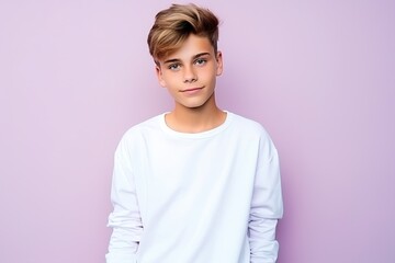 Fototapeta premium A young boy with blonde hair and blue eyes is wearing a white shirt