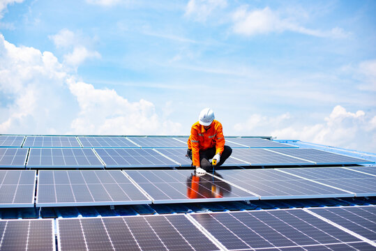 Engineer service check installation solar cell on the roof of factory , Sustainable energy industry concept, Renewable energy solution for climate change