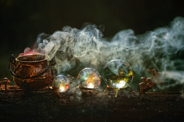 steaming witch copper cauldron and crystal balls in forest close up, abstract dark natural background. occultism, magic ritual, witchcraft. wicca, esoteric spiritual practice. fairytale, mystery image