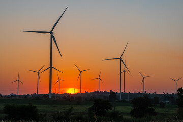 Landscape of Wind turbine farm in beautiful nature with sunset blackground, generating electricity in Nakorn Ratchasima Thailand