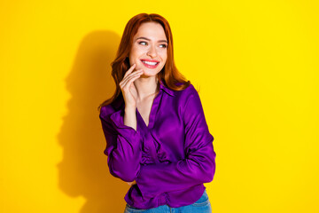 Photo portrait of pretty young girl look minded empty space wear trendy purple outfit isolated on yellow color background