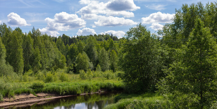 Panoramic view of the sandy bank of the Sarka river with low water in the Leningrad region in good weather in the village of Ust-Sara