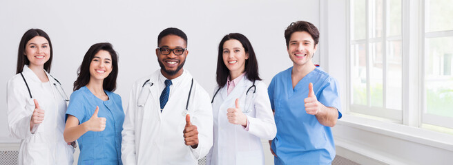 Medicine Concept. Happy Doctors Showing Thumbs Up At Hospital