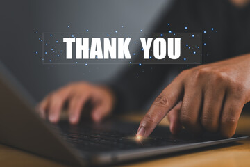 businessman using a laptop and showing the message thank you on a display screen. concept of thank you business, appreciation and gratitude, congratulations, presentation from technology digital