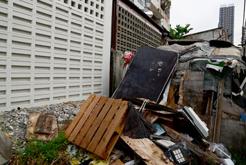 The Old Black Mattress piled up with rubbish on the side of the road in the forest background at Thailand.