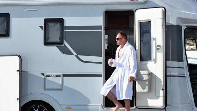 Tourist Living Camper Van in Robe with Cup of Coffee in His Hand