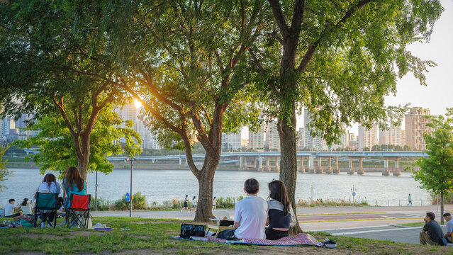 People enjoying a picnic at Hangang Park at sunset