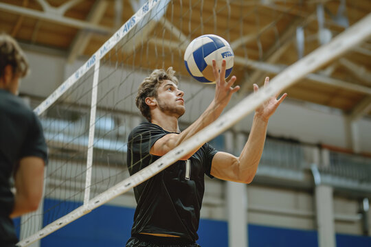 Male Volleyball Player Preparing to Set the Ball in Indoor Game