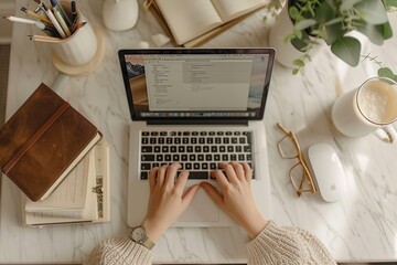 Freelancer Working on Laptop in Cozy Home Office, Coffee and Notebook on Desk, Overhead View. Hands with laptop Top view. Aesthetic lifestyle photo