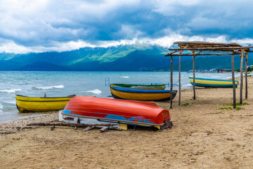 A view of boats pulled up on the shores of Lake Ohrid in Podgradec, Albania in summertime